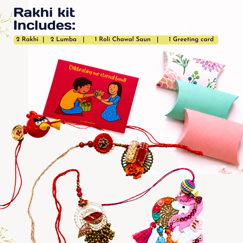 Rakhi gift kit contents arranged on a white background with text reading 'Rakhi kit Includes:'. Visible items include two red Rakhi threads with decorative charms, a red greeting card with an illustration, two pastel pillow boxes, and a small red Angry Birds charm.