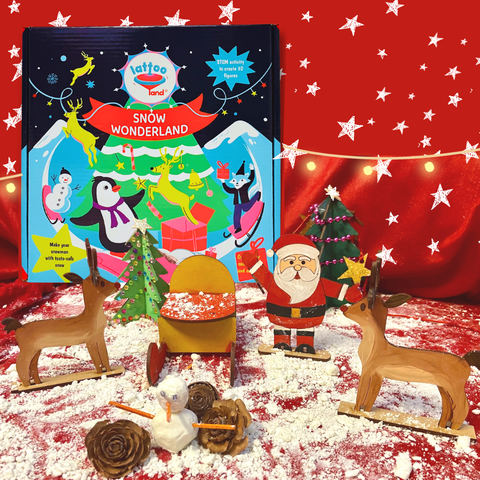 Lattooland Snow Wonderland christmas kit with snow in seconds instant and art and craft Christmas-themed toys on a red background with star decorations christmas tree Santa Claus sleigh reindeer snowman