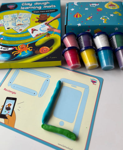 Creative play session with flashcards and playdough forming letters and numbers.